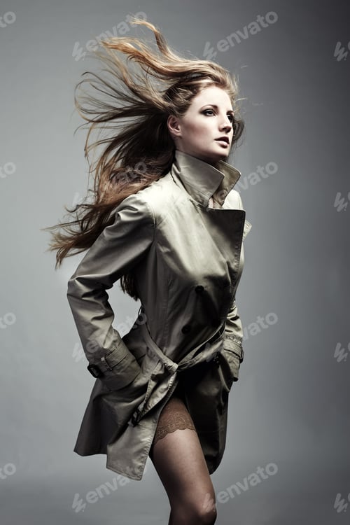 Preview: Fashion portrait of young beautiful woman in the raincoat