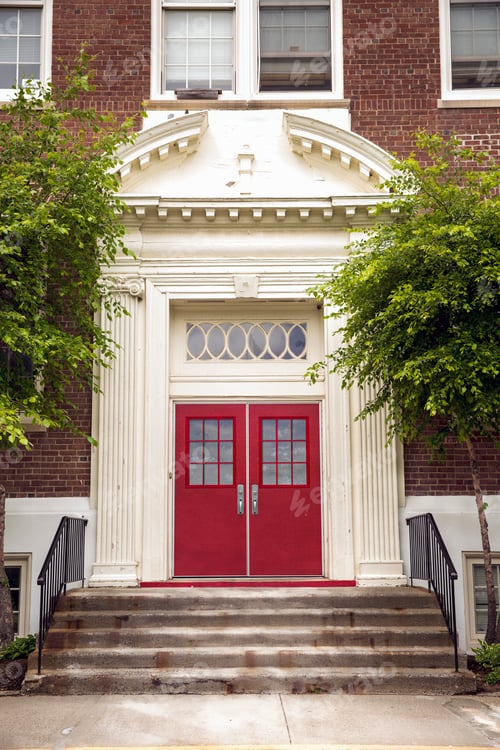 Preview: Stairway entrance to traditional elementary school with red door