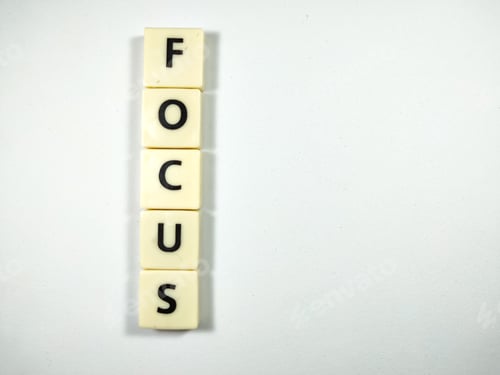 Preview: Scrabble letters with text FOCUS on white background.