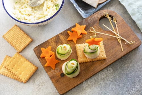 Preview: Cooking Christmas trees of ham, cucumber, cheese and star of carrot on crackers, step 4.