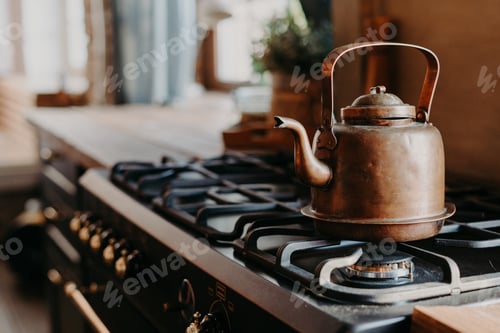 Preview: Old aluminium kettle boiling on gas stove in kitchen against cozy blurred background