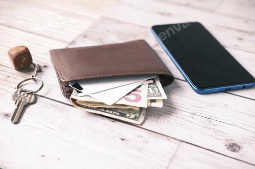 Preview: close up of wallet, cash and credit card on table