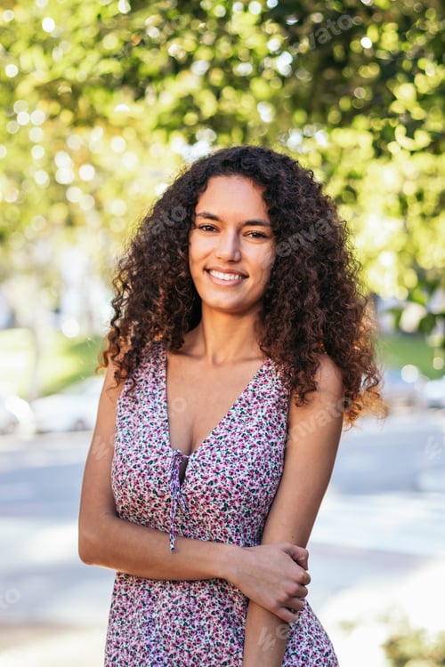 Preview: Portrait of a cheerful Latin American young woman outdoors