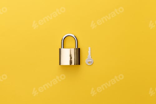 Preview: top view of padlock near key on yellow background