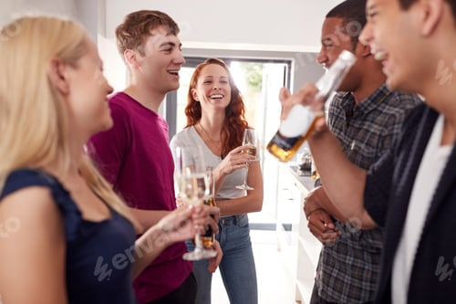 Preview: Group Of College Students In Shared House Kitchen Hanging Out And Drinking Together