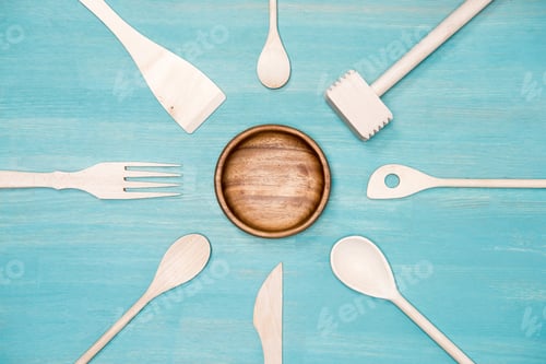 Preview: top view of various wooden cooking utensils with plate