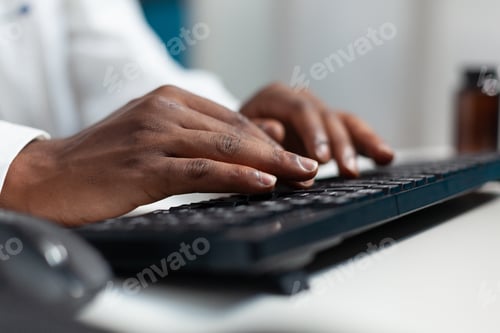 Preview: Closeup of african american therapist doctor typing medical expertise