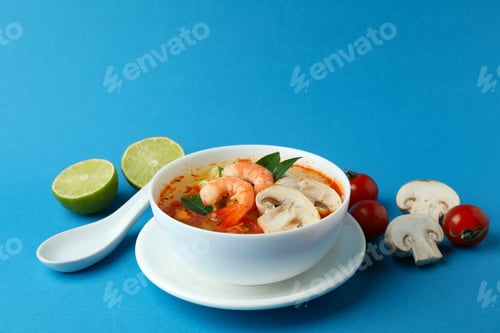 Preview: Tasty Tom yum soup on blue background