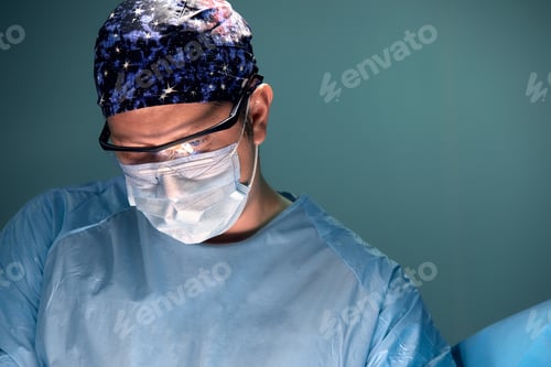 Preview: Doctor performing surgery in dark operation room with lamp on background