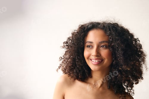 Preview: Studio Portrait Of Smiling Natural Woman With Bare Shoulders Standing Against Neutral Background