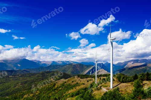 Preview: Aerial view of wind turbine farm. Wind power plants in green summer landscape with clouds.