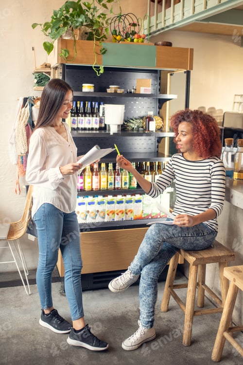 Vista previa: Young successful women owning coffee shop working together