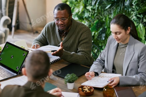 Preview: Middle Aged Black Man Leading Business Meeting with Diverse Colleagues
