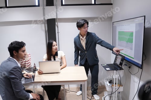 Preview: Business team analyzing data during meeting presentation