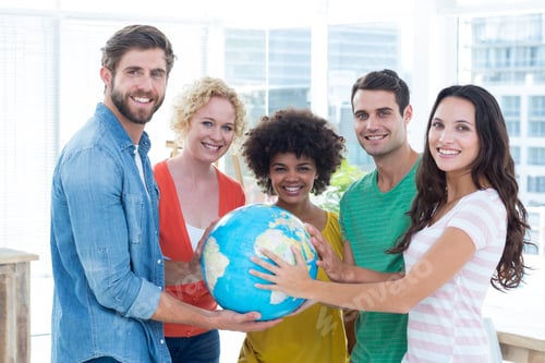 Preview: Young Creative Business People With A Globe In The Office