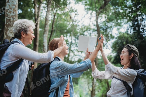 Preview: Group of diverse women exploring nature, smiling and studying wildlife in the forest