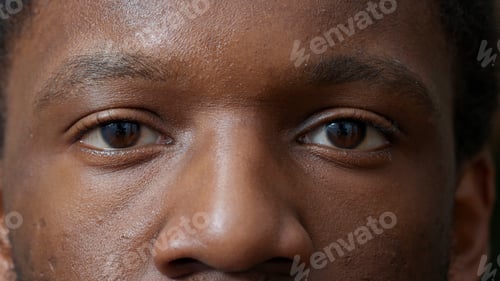 Preview: Macro shot of young adult blinking in front of camera