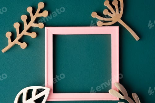 Preview: pink pastel photo frame with wooden leaf on green table