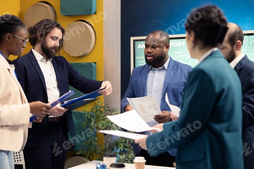 Preview: Employees team analyzing infographics to offer solutions on an issue