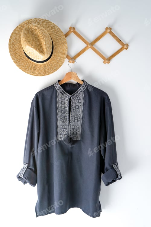 Preview: Ukrainian clothes embroidered man shirt. Blue gray and black threads background. Vyshyvanka is a