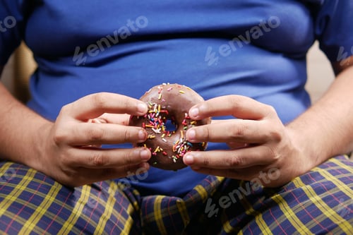 Preview: young man eating donut , selective focus