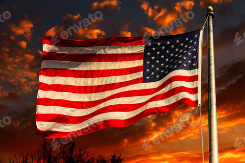 Preview: Orange glow sky sunset american flag in front of bright sky with white clouds
