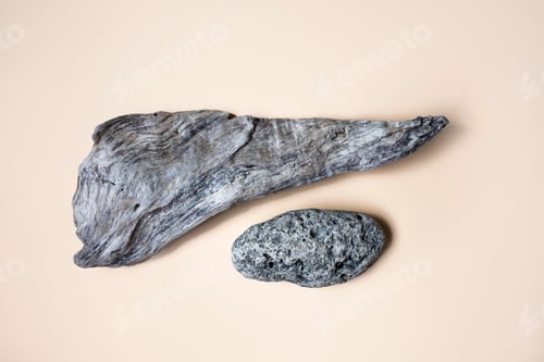 Preview: Gray wood and stone on a beige background. Top view, place for text.