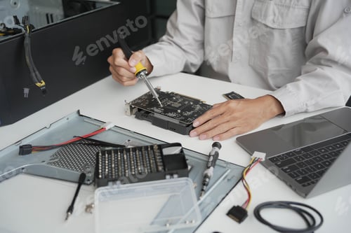 Preview: Technician Repairing Electronic Components in Urban Workspace