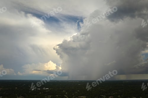 Preview: Dark stormy clouds forming on gloomy sky during heavy rainfall season over suburban town area