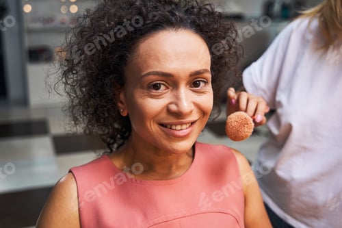 Preview: Portrait of happy female person doing makeup