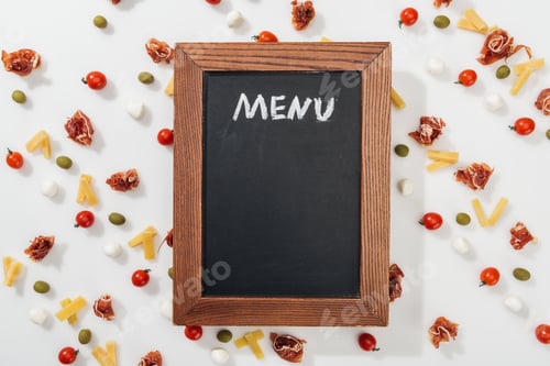 Preview: chalk board with menu lettering among olives, prosciutto, mozzarella, cut cheese and cherry tomatoes