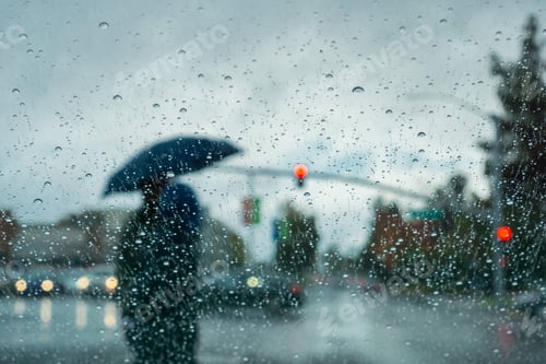 Preview: Blurred people silhouettes crossing a street