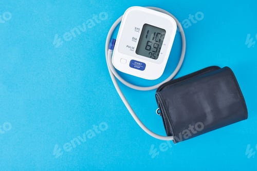 Preview: Digital blood pressure monitor on a blue background, closeup. Helathcare and medical concept