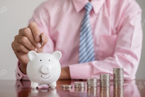 Preview: The hand of a businessman puts coins in a piggy bank, saves money with coins, steps into