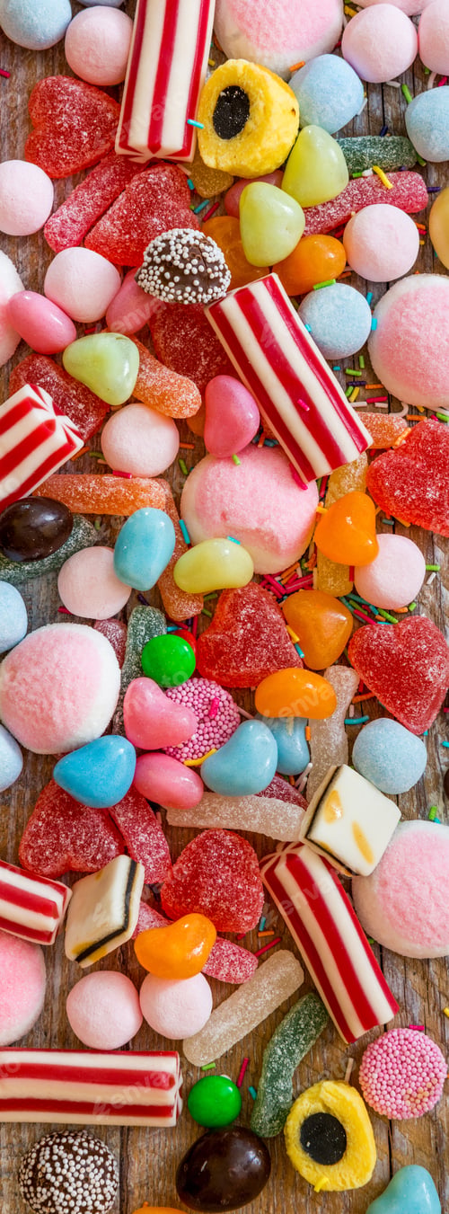 Preview: variety of candies on a wooden background