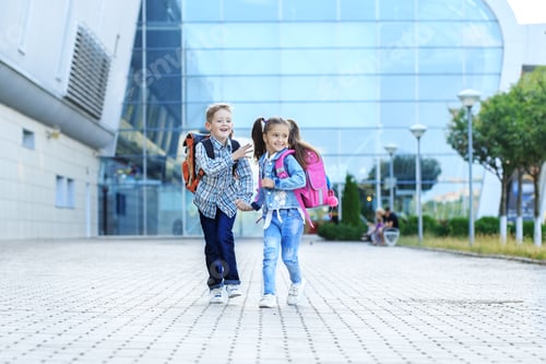 Preview: Children run with backpacks from school. The concept is back to school, study, friendship.