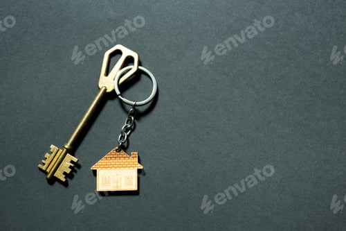 Preview: Key chain in the shape of house with key on a black background.