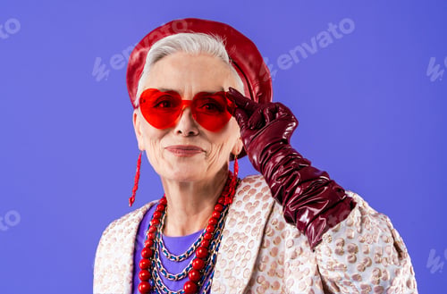 Preview: Happy and funny senior old woman on colorful background