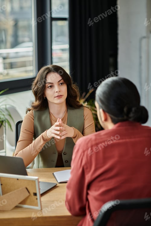 Preview: Colleagues Discussing Challenges During Layoff Meeting in Contemporary Office Space