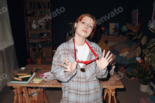 Preview: Portrait of Caucasian Teenager Girl Showing Medal in Cozy Bedroom Setting