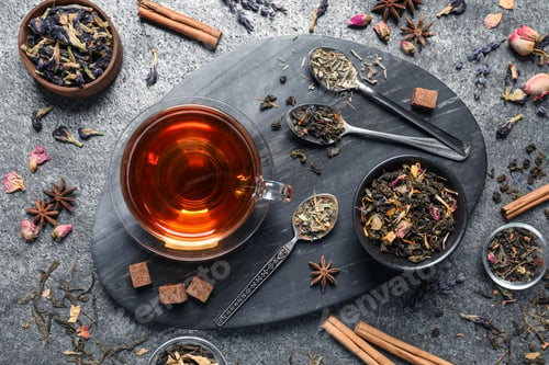 Preview: Flat lay composition with freshly brewed tea and dry leaves on grey table