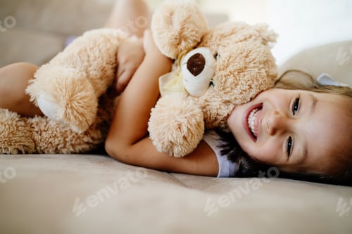 Preview: Cute little girl playing with teddy bear