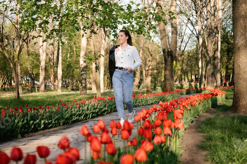 Preview: Spring is coming. Enjoy spring, Savor Springtime. Beautiful young woman among bright tulips in