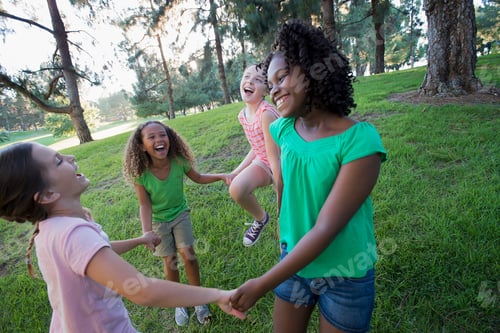 Preview: A group of four girls holding hands and dancing outside.
