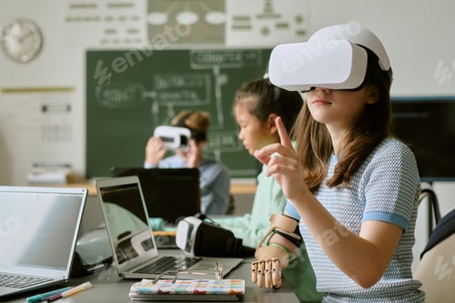 Preview: Caucasian Teen Girl Using Virtual Reality Headset in Classroom Setting
