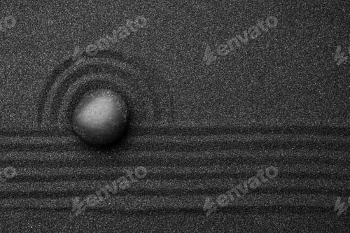 Preview: Black sand with stone and beautiful pattern, top view. Zen concept