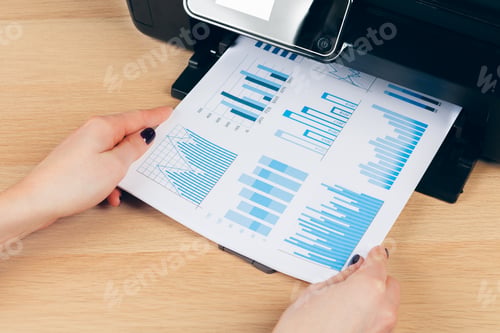 Preview: Female secretary making photocopies on xerox machine in office