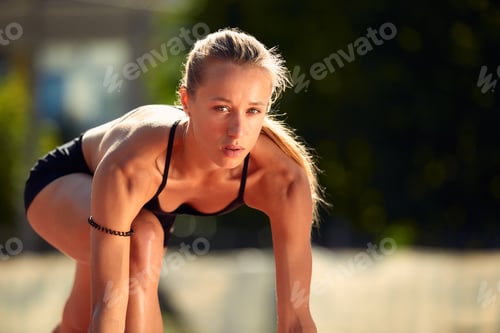 Preview: Woman getting ready to start on Stadium - summer outdoors training.