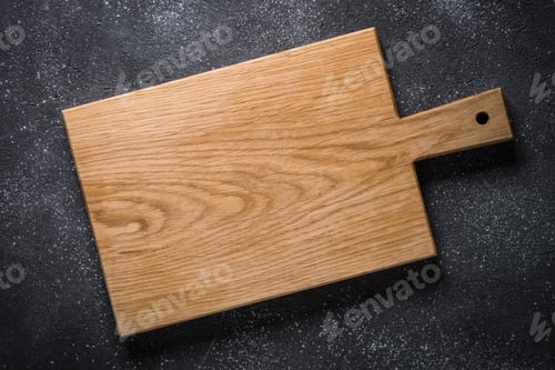 Preview: Empty wooden cutting board on black stone table