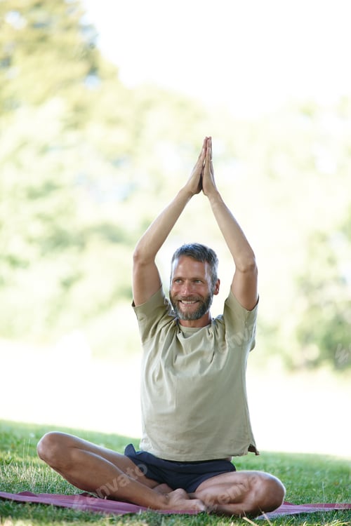 Preview: Man Practicing Yoga Outdoors in a Green Field
